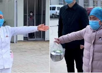 Suster terpaksa peluk anaknya dari jauh karena virus korona .Foto : Xinhua News